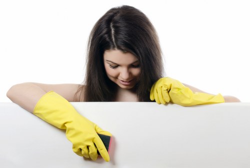 Cleaner washing glass on a residential property in Richmonduponthames